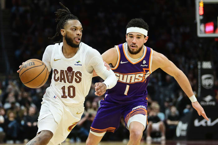Mar 11, 2024; Cleveland, Ohio, USA; Cleveland Cavaliers guard Darius Garland (10) drives to the basket against Phoenix Suns guard Devin Booker (1) during the second half at Rocket Mortgage FieldHouse.